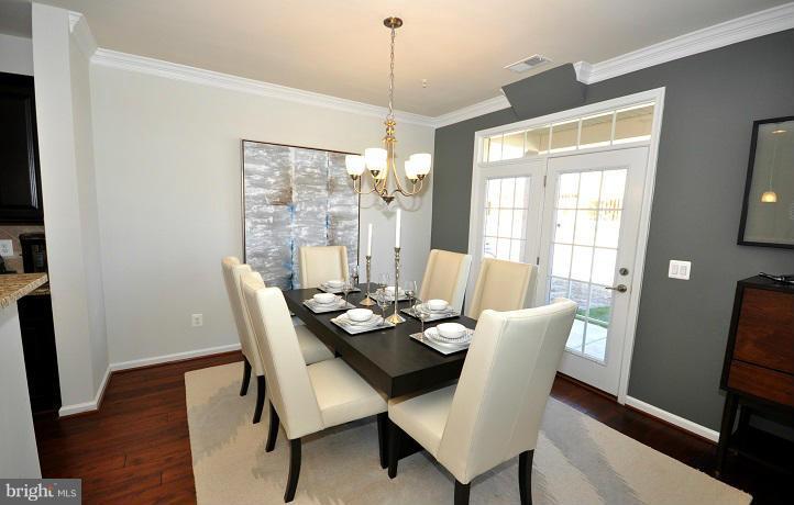 42590 Sunset Ridge Square Ashburn, VA 20148 - Photo 3 of 13 a dining room with furniture a chandelier and wooden floor
