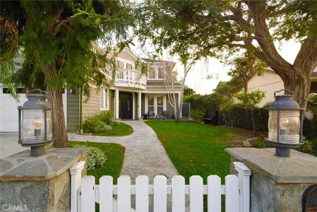 a front view of a house with yard and green space