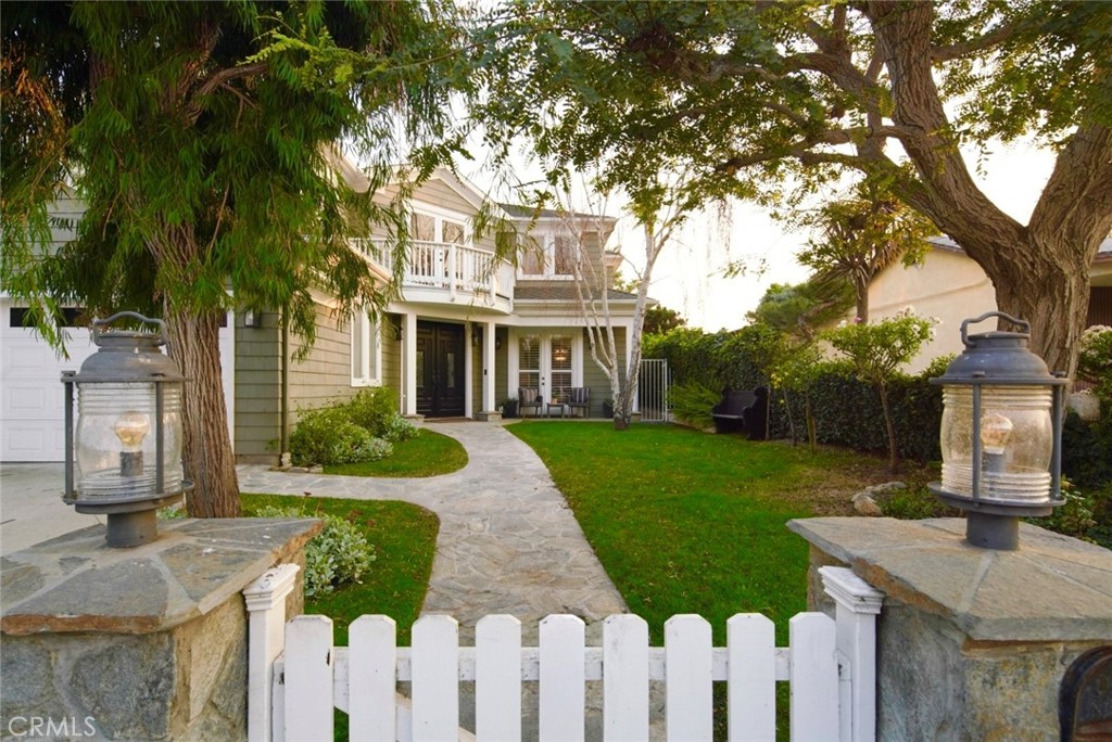 a front view of a house with yard and green space