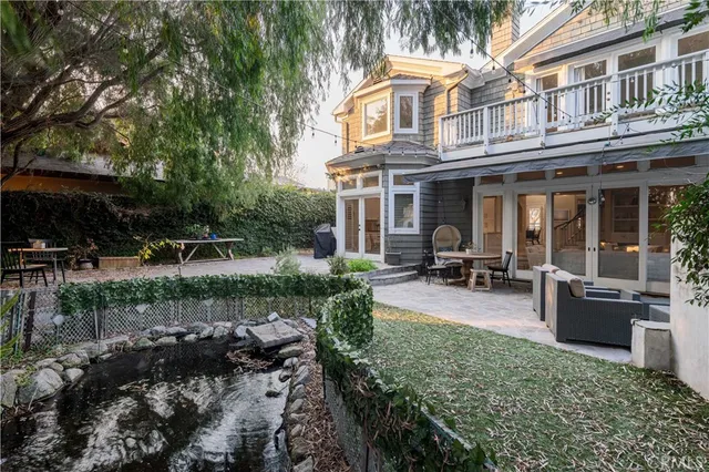a view of a house with backyard porch and sitting area
