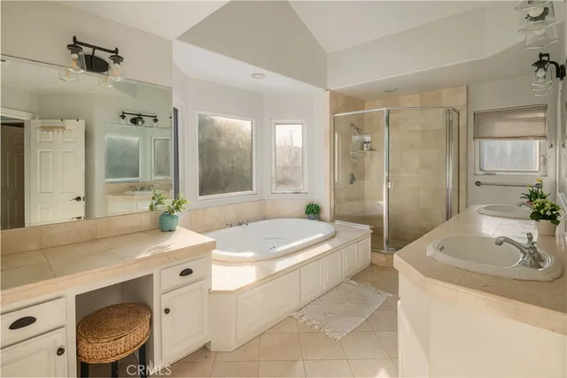 a bathroom with a sink a toilet a mirror and shower