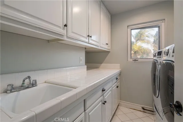 a kitchen with stainless steel appliances granite countertop a sink and a refrigerator