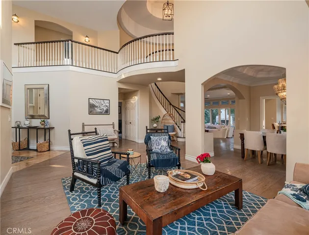 a living room with furniture a rug and a chandelier