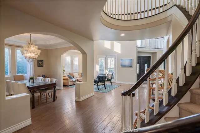 a view of a livingroom with furniture wooden floor and a chandelier