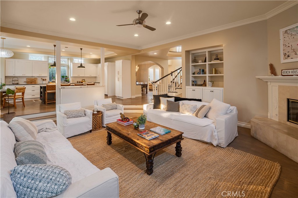 1534 3rd Street Manhattan Beach, CA 90266 - Photo 8 of 21 a living room with furniture a rug kitchen view and a chandelier