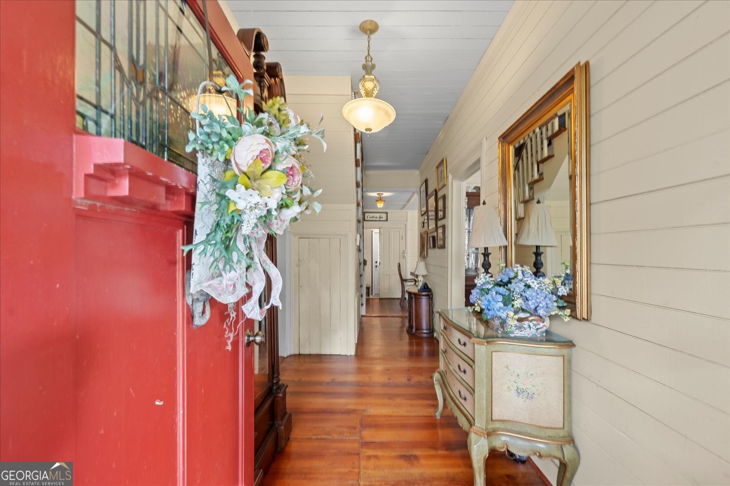 6644 East Cadley Road Norwood, GA 30821 - Photo 6 of 53 a hallway with beautiful flowers and wooden floor