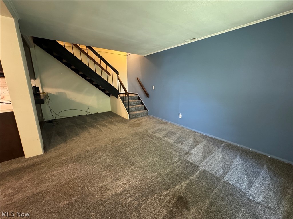 7294 Fox Mill Road, Unit 19D Mentor, OH 44060 - Photo 4 of 27 Spacious room featuring carpet and a staircase with metal balusters