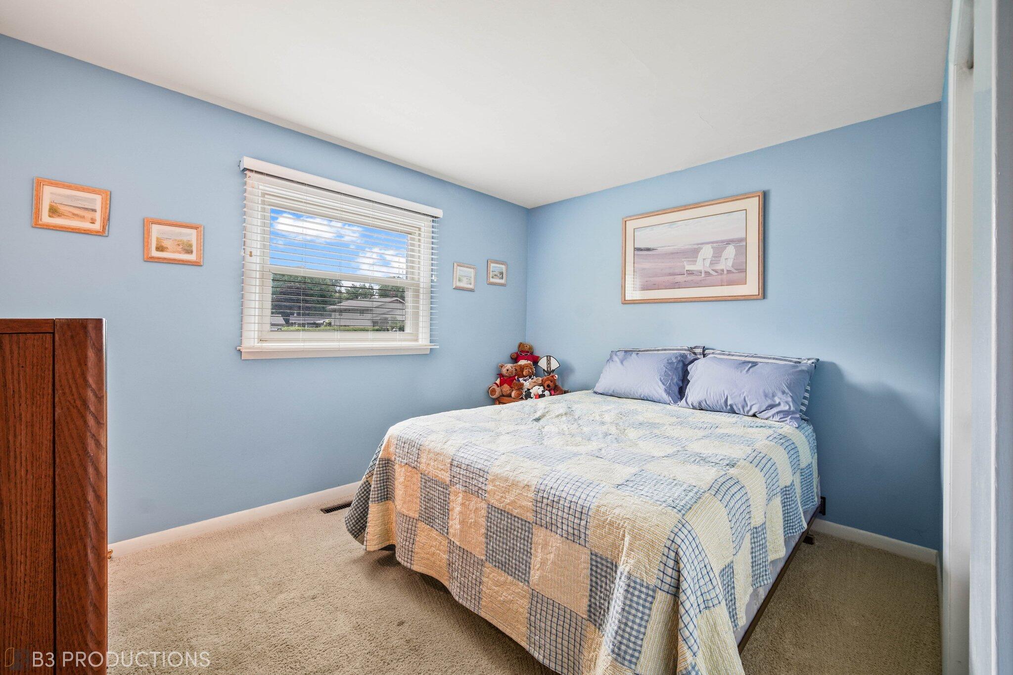 55 Deep River Drive Hobart, IN 46342 - Photo 12 of 21 a bed room with a bed and a painting on the wall