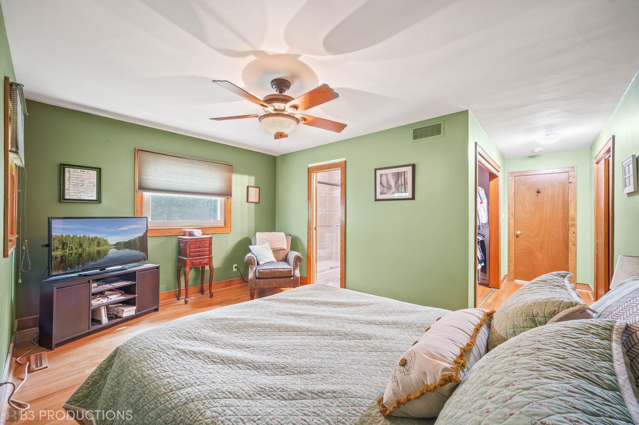 55 Deep River Drive Hobart, IN 46342 - Photo 15 of 21 a bedroom with a bed and a chandelier