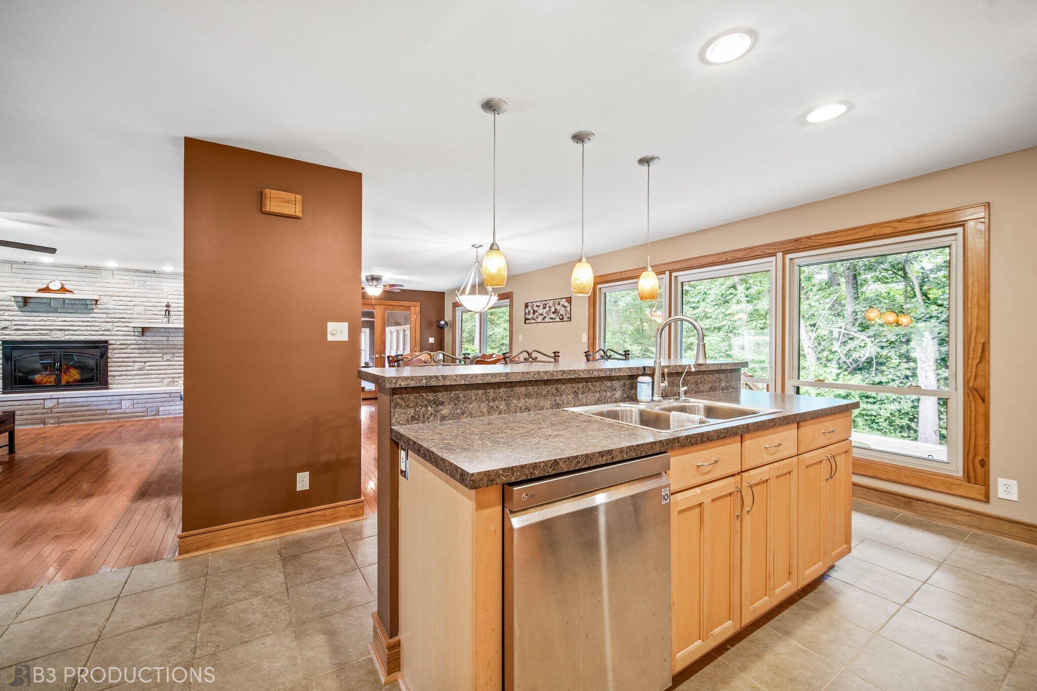 55 Deep River Drive Hobart, IN 46342 - Photo 10 of 21 a kitchen with kitchen island a sink a counter top space appliances and a cabinets