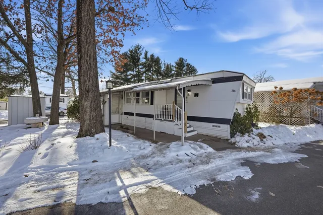 a view of a house with a yard covered in snow