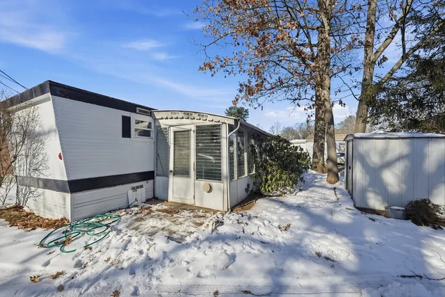 a backyard of a house with large trees and barbeque oven