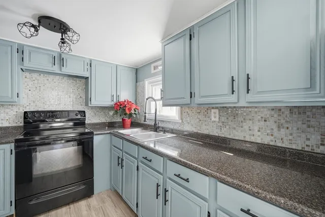 a kitchen with a sink stove and cabinets