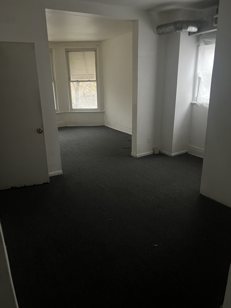 1845 East 93rd Street, Unit 2E Chicago, IL 60617 - Photo 3 of 8 a view of a room that has a window in it