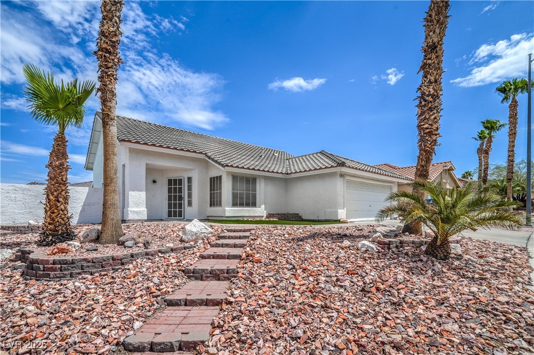 818 Coastal Beach Road Henderson, NV 89002 - Photo 1 of 39 View of front of home featuring a garage, stucco siding, a tile roof, and driveway