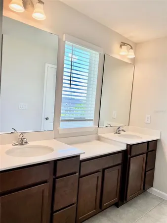 a bathroom with a double vanity sink and a mirror