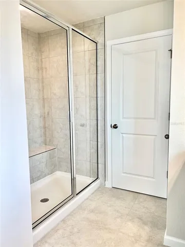 a bathroom with a glass shower door
