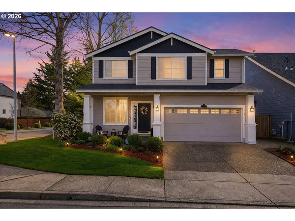 a front view of a house with a yard and garage