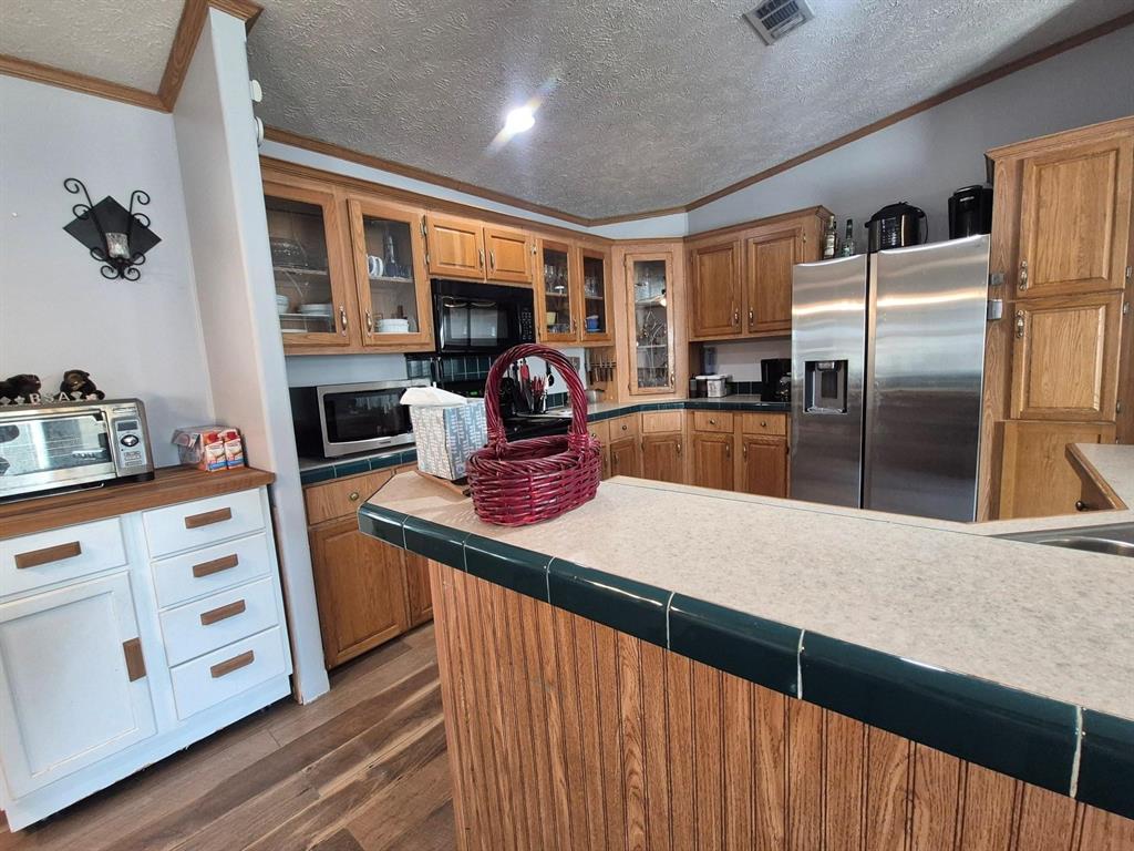 438 Silver River Road Gholson, TX 76705 - Photo 20 of 39 a kitchen with stainless steel appliances granite countertop a sink a stove and a refrigerator