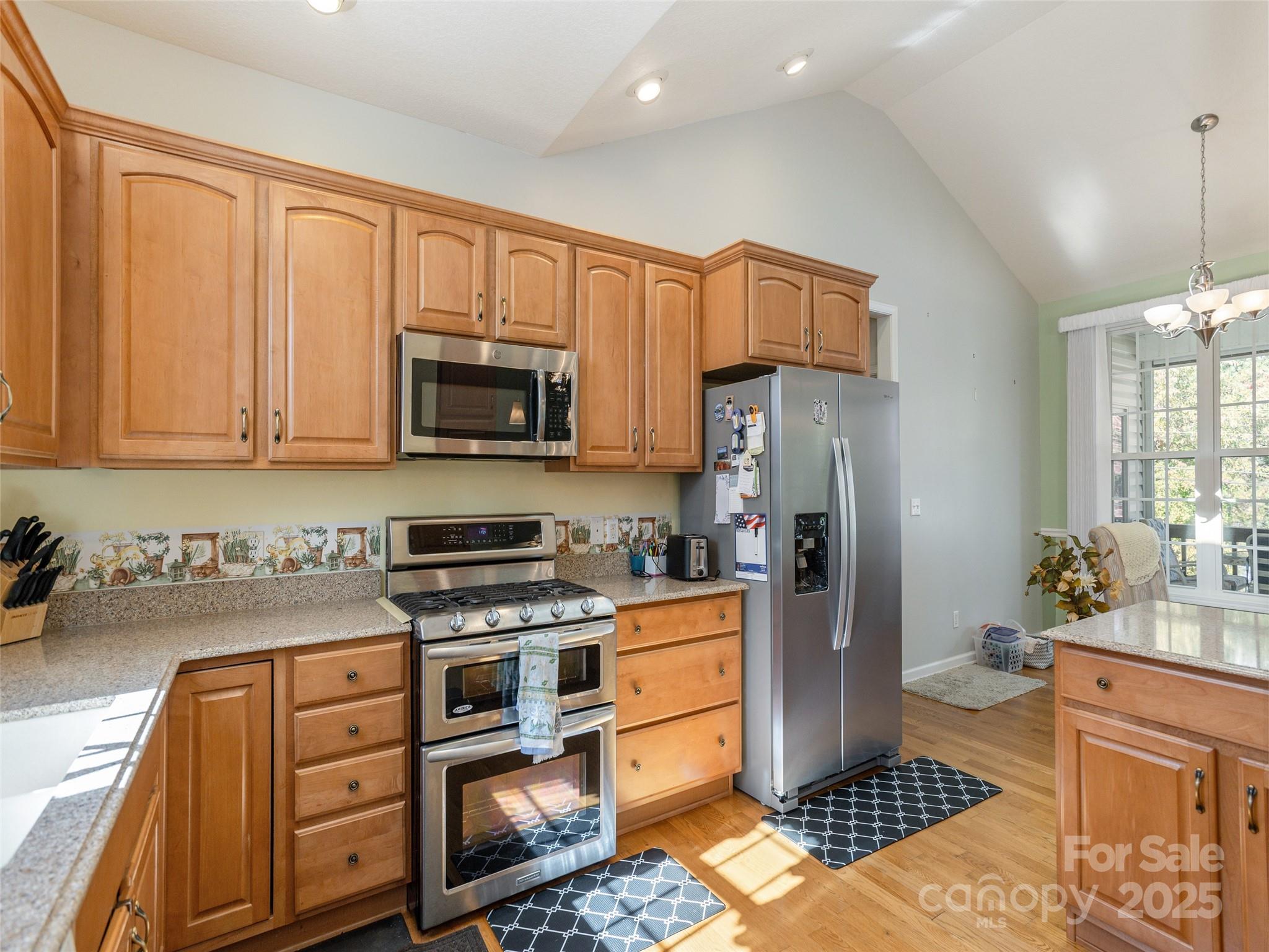 249 Stone House Road Hendersonville, NC 28739 - Photo 14 of 33 a kitchen with stainless steel appliances granite countertop a refrigerator stove and sink