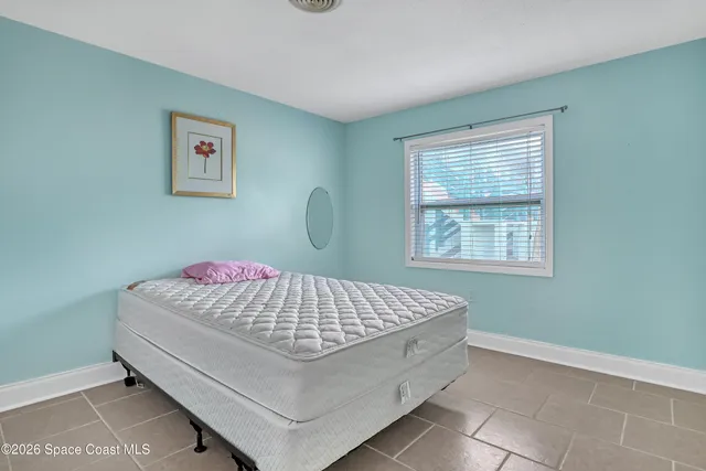 a living room with a bed furniture and a window