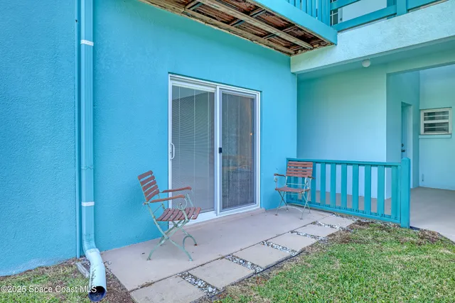 a backyard of a house with table and chairs
