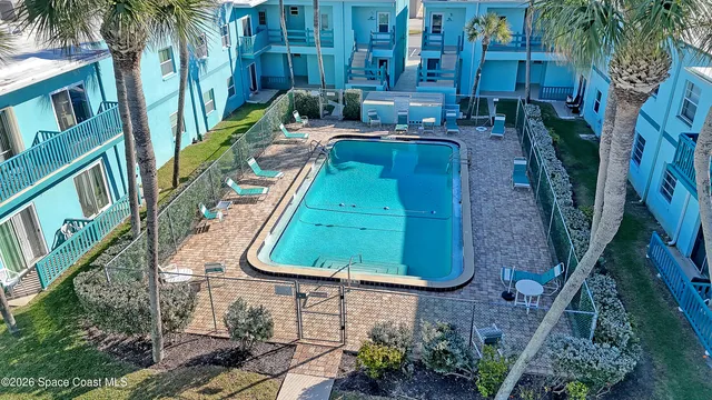 a view of a backyard with plants and a water fountain