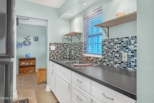 a kitchen with granite countertop a sink and a stove