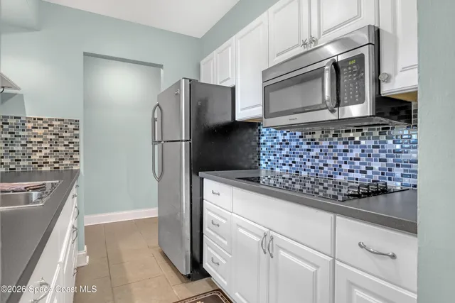 a kitchen with granite countertop a stainless steel appliances and cabinets