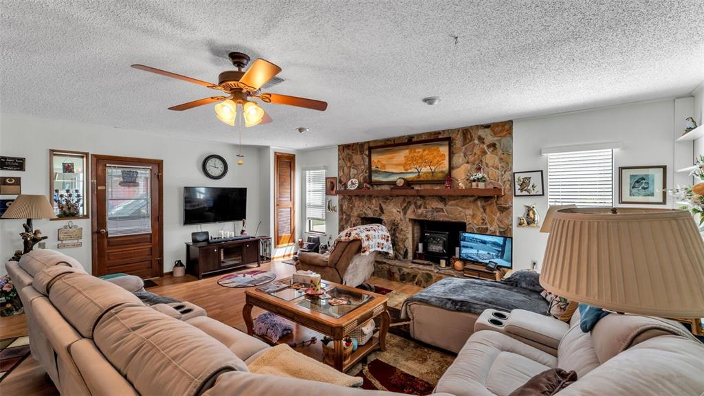 1301 Lanier Road Lakeland, FL 33810 - Photo 14 of 45 a living room with furniture a fireplace and a flat screen tv
