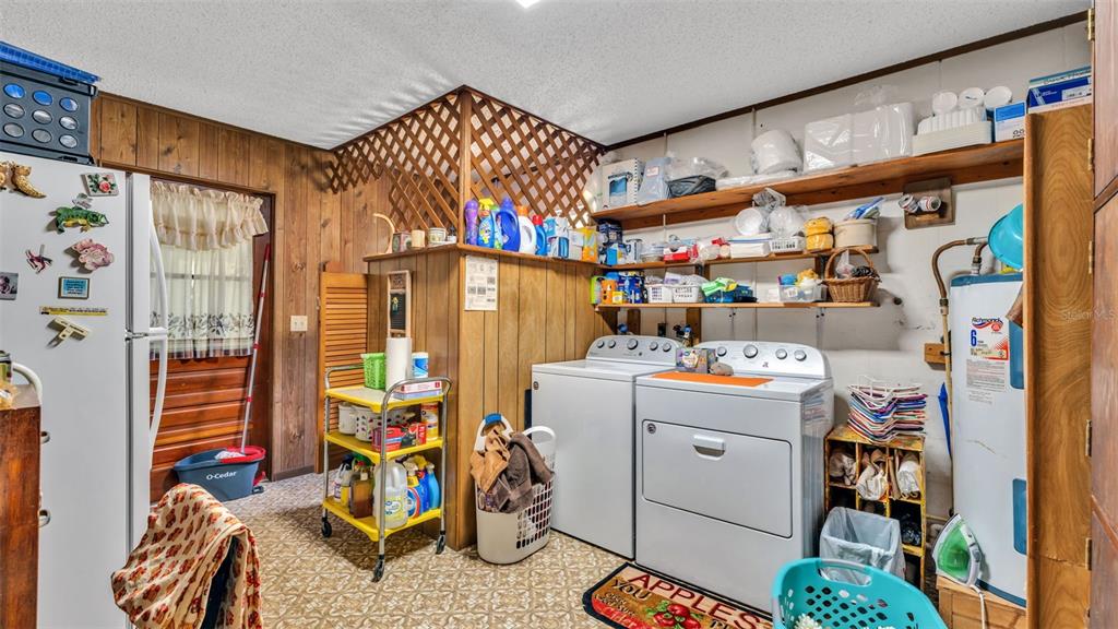 1301 Lanier Road Lakeland, FL 33810 - Photo 18 of 45 a utility room with fridge dryer and bicycles
