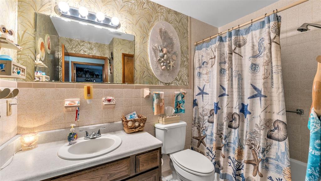 1301 Lanier Road Lakeland, FL 33810 - Photo 20 of 45 a bathroom with a sink vanity mirror and toilet