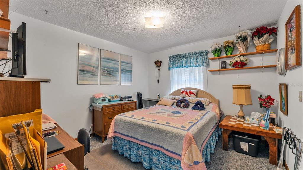 1301 Lanier Road Lakeland, FL 33810 - Photo 21 of 45 a bedroom with a bed and wooden floor