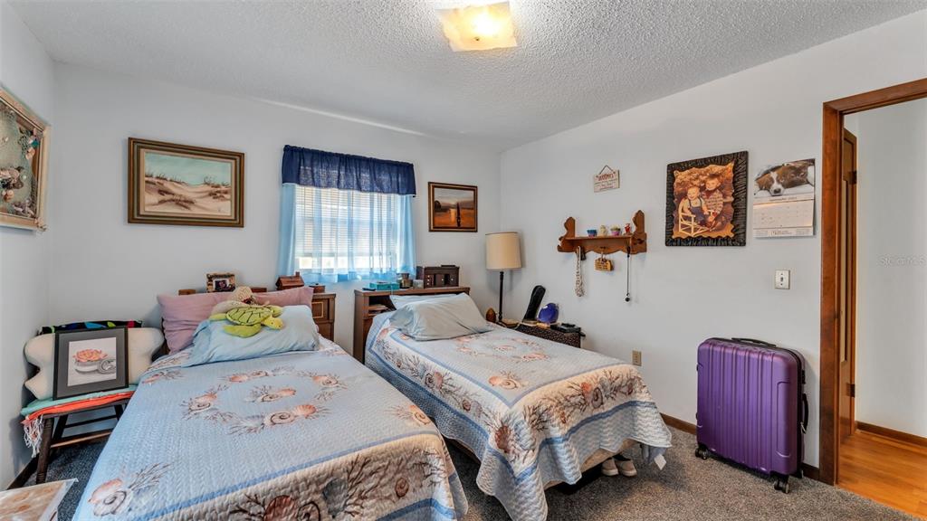 1301 Lanier Road Lakeland, FL 33810 - Photo 24 of 45 a bedroom with two beds and a lamp