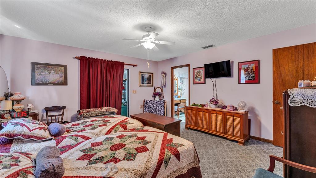 1301 Lanier Road Lakeland, FL 33810 - Photo 26 of 45 a bedroom with a bed and a flat screen tv