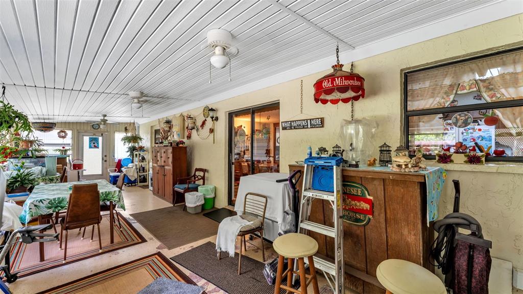 1301 Lanier Road Lakeland, FL 33810 - Photo 32 of 45 a very nice looking dining room with kitchen island stainless steel appliances furniture a fireplace and a chandelier
