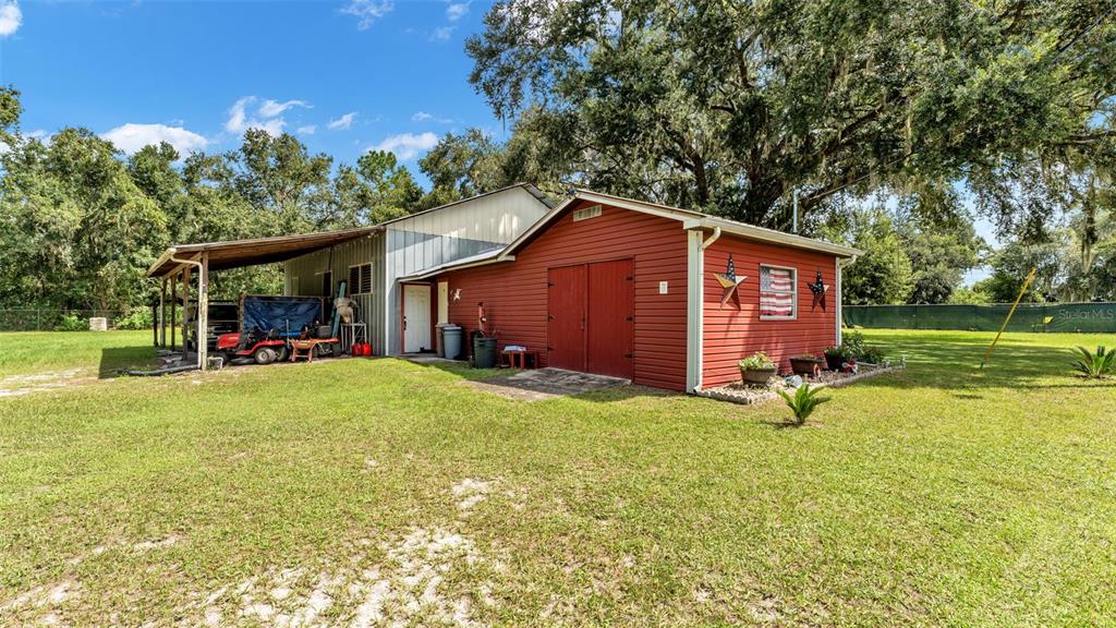 1301 Lanier Road Lakeland, FL 33810 - Photo 36 of 45 a view of a house with backyard porch and garden