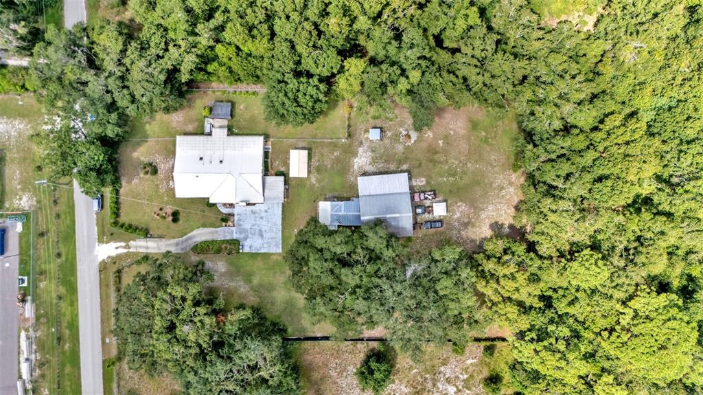 1301 Lanier Road Lakeland, FL 33810 - Photo 42 of 45 an aerial view of residential house with outdoor space and trees all around