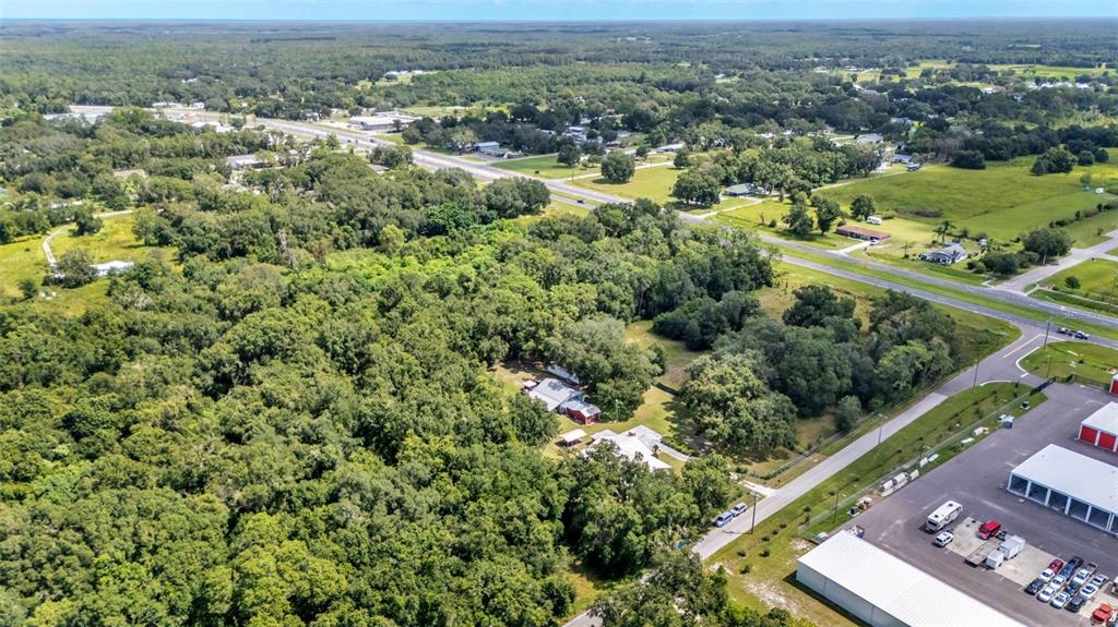 1301 Lanier Road Lakeland, FL 33810 - Photo 44 of 45 an aerial view of a residential houses with outdoor space and trees