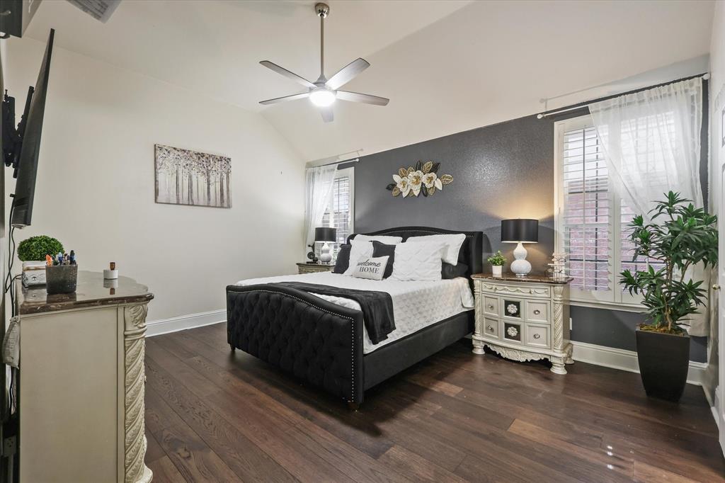 1973 Garrison Way Garland, TX 75040 - Photo 16 of 29 a bedroom with a bed and a potted plant