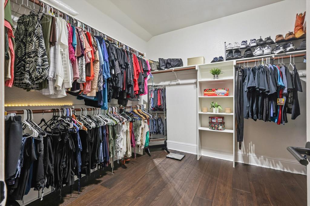 1973 Garrison Way Garland, TX 75040 - Photo 18 of 29 a view of walk in closet with clothes