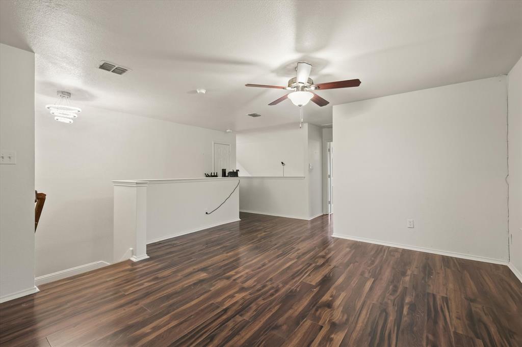 1973 Garrison Way Garland, TX 75040 - Photo 20 of 29 a view of a room with wooden floor and a ceiling fan