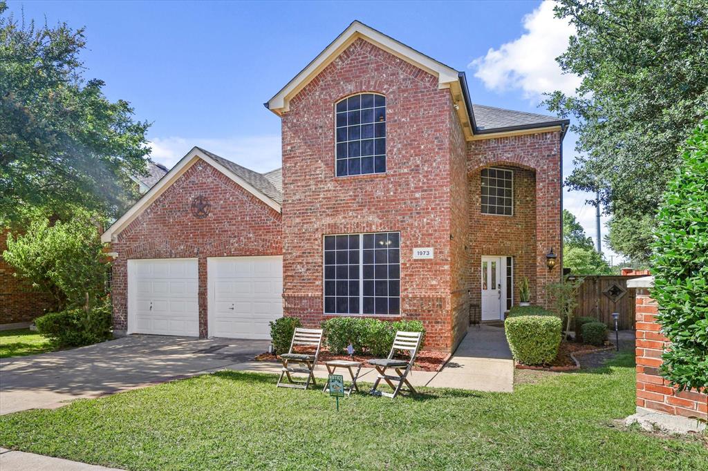 1973 Garrison Way Garland, TX 75040 - Photo 2 of 29 a front view of a house with a yard and outdoor seating