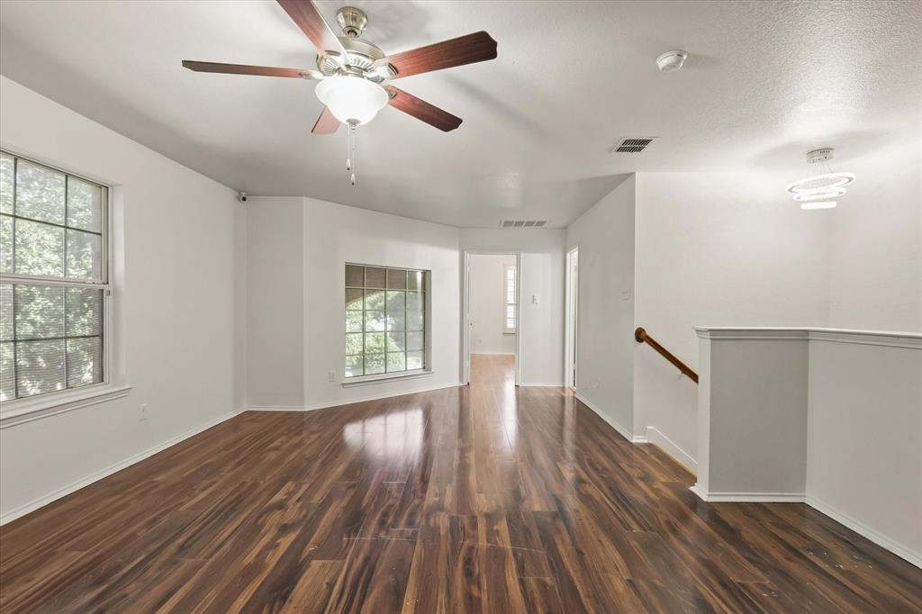1973 Garrison Way Garland, TX 75040 - Photo 21 of 29 a view of an empty room with wooden floor and a window