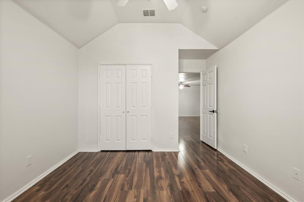 1973 Garrison Way Garland, TX 75040 - Photo 25 of 29 a view of an empty room with wooden floor and closet