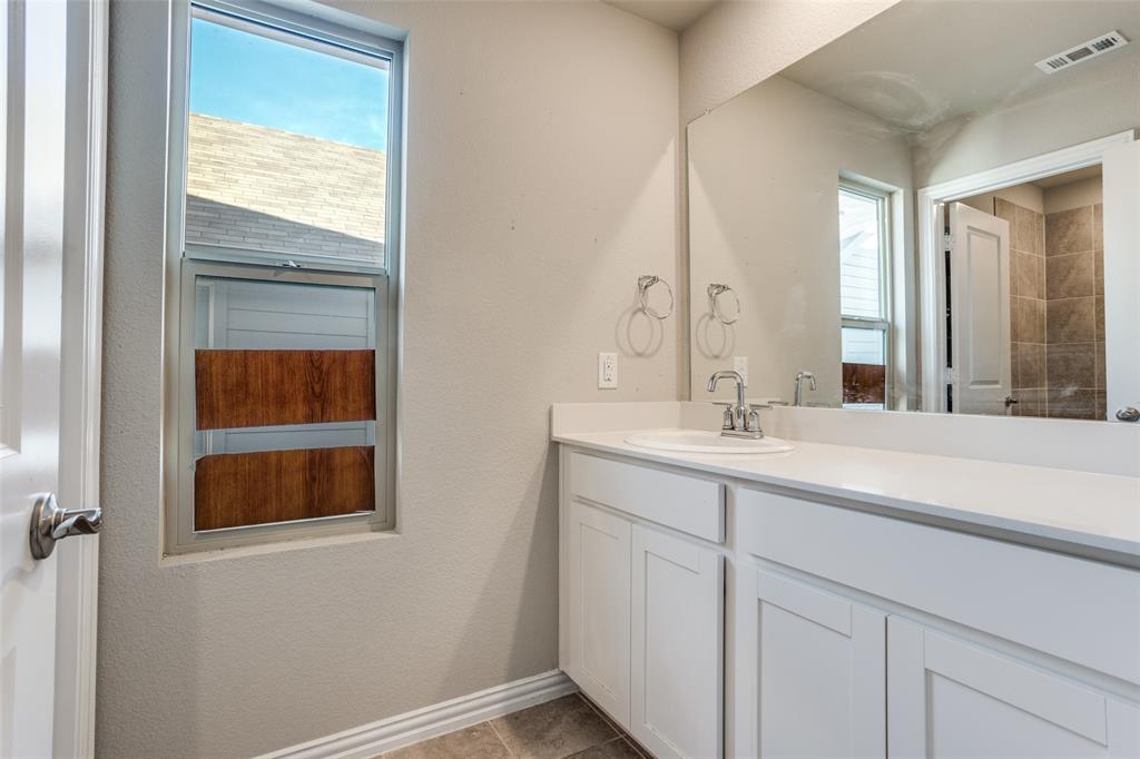 3808 Barnett Road Rowlett, TX 75089 - Photo 12 of 13 a bathroom with a sink and a mirror