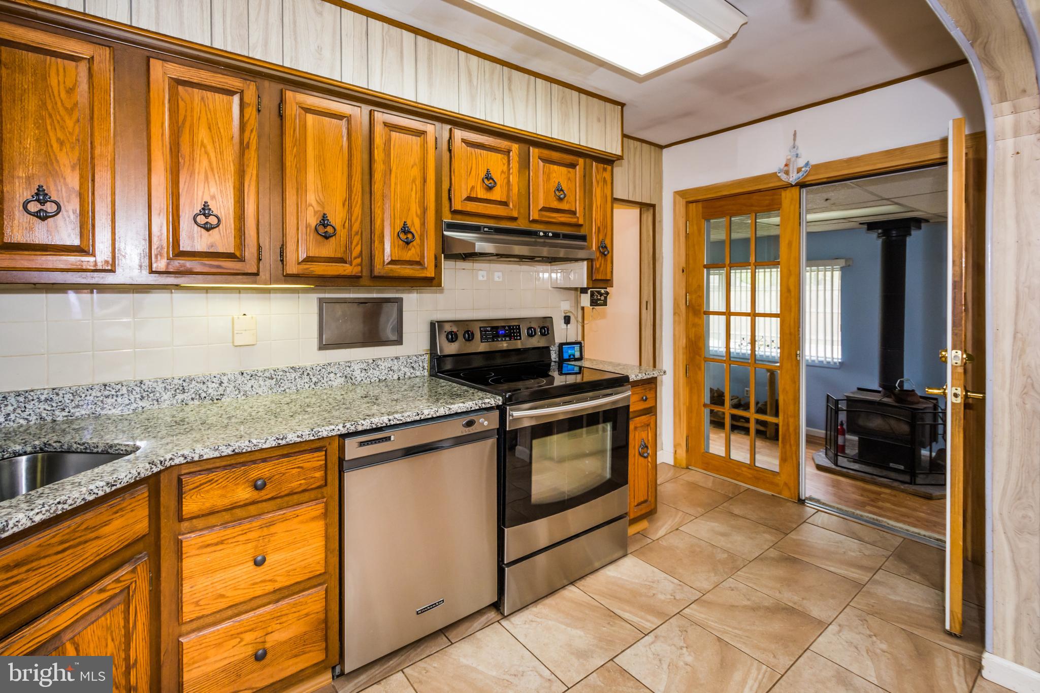 8436 Alvin Road Pasadena, MD 21122 - Photo 8 of 38 Kitchen (view 4) towards Florida Room w/wood stove
