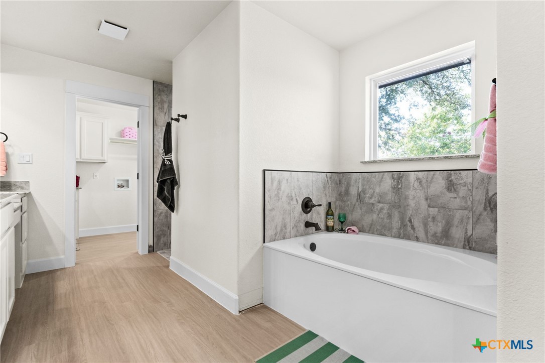 3025 Millhouse Road Copperas Cove, TX 76522 - Photo 18 of 43 a bathroom with a bathtub and a shower