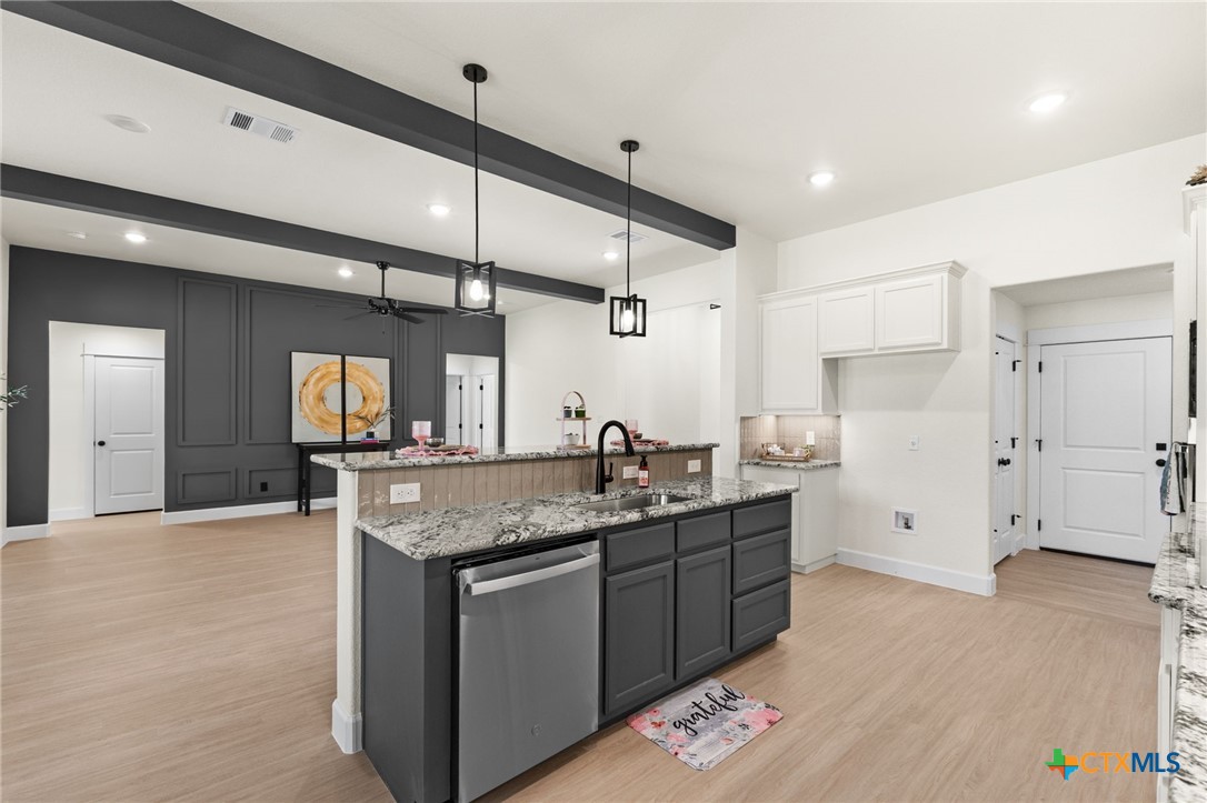 3025 Millhouse Road Copperas Cove, TX 76522 - Photo 9 of 43 a kitchen with stainless steel appliances granite countertop a sink and a refrigerator