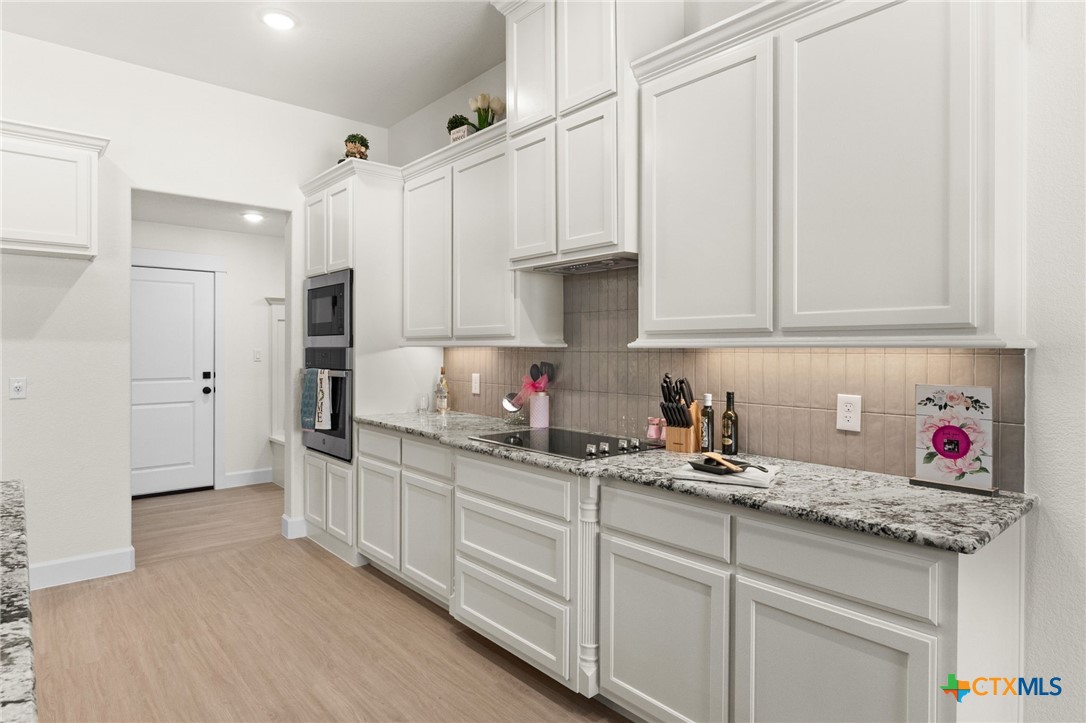 3025 Millhouse Road Copperas Cove, TX 76522 - Photo 10 of 43 a kitchen with stainless steel appliances granite countertop a sink and cabinets